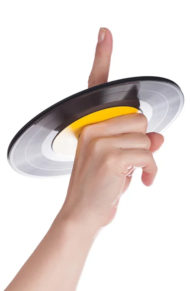 Vinyl record on a female finger — Stock Photo, Image