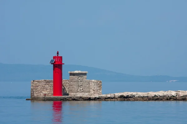 Lighthouse at port entrance — Stock Photo, Image