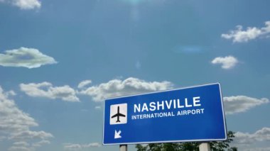 Jet uçağı Nashville, Tennessee, ABD 'ye iniyor. Havaalanı istikameti işaretli şehir gelişi. Seyahat, iş, turizm ve uçak taşımacılığı kavramı.