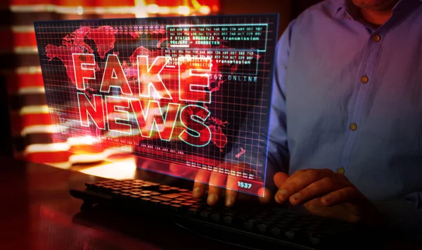 Fake news on computer screen. Broadcast, trolling, false information, hoax, propaganda, information and disinformation abstract concept 3d with glitch effect. Man typing keyboard.