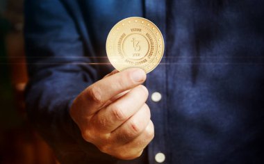 Tezos XTZ açık kaynak, eşdeğer kripto para sembolü elde soyut konsept altın sikke.