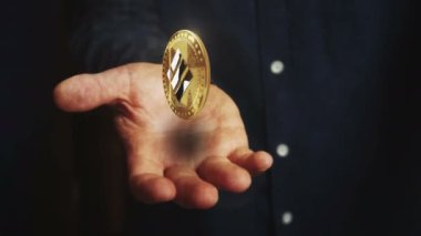 Binance BUSD stablecoin cryptocurrency rotating 3d coin hovers over the hand. Businessman with symbol floating above the hand. Business and technology seamless and looped abstract concept.