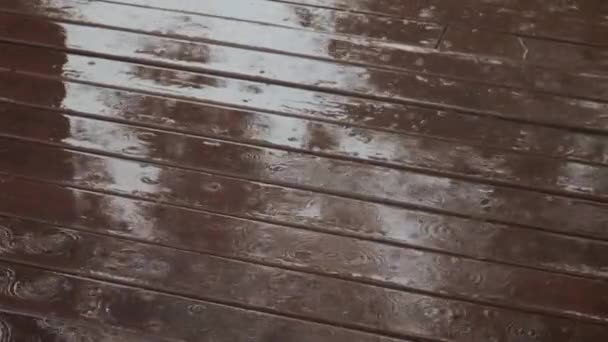 Chuva no chão de madeira marrom. Movimento lento — Vídeo de Stock