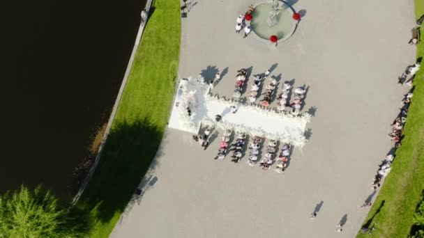 Aerial drone view wedding at lake, promenade with guests. event outdoor celebration. — Stock Video