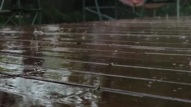 Raining on the brown wood floor. Slow motion view — Stock Video