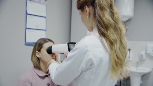 Офтальмолог осматривает глаза пациентов. Закрыть съемку — стоковое видео