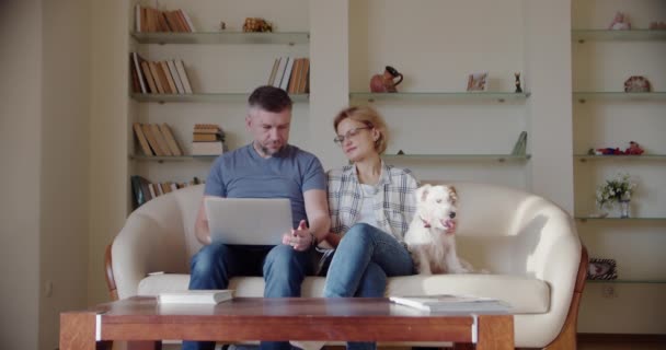 Happy Couple Sitting on the Sofa Playing Video Games, Using Controllers.  Competitive Girlfriend and Boyfriend in Love have Fun Playing in Online  Video Games at Home Together. Close-up Focus on Hands Stock