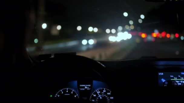 Οι οδηγοί χέρι στο τιμόνι του νυχτερινού δρόμου και την λάμψη των διερχόμενων αυτοκινήτων. Κλείσε. — Αρχείο Βίντεο