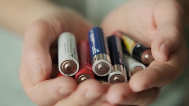 Hands holding alkaline batteries heap. Concept of Recycling, energy, power, environment and ecology. Close up view — Stock Video