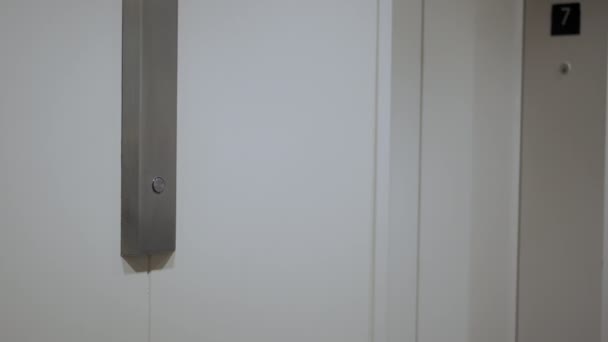 Zamknij drzwi. Mans ręka naciska przycisk windy, aby przejść w górę. — Wideo stockowe