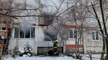Wide shot of Fireman sprays the blazing rubble of a demolished house on Street. . Ivano Frankivsk 20 dec 2021 Ukraina