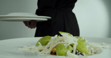 Close up footage of a man hand chef prepares a salad of seafood and vegetables, Slow motion