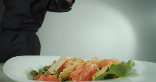 Primer plano de un hombre mano chef, prepara una ensalada de mariscos y verduras — Vídeos de Stock