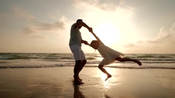 Feliz padre e hija jugando en la playa al atardecer — Vídeos de Stock