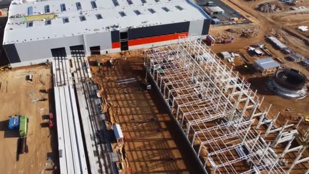 Aerial drone shot of a New Constructions Development Site warehouses Projects and Heavy Machinery and Construction Workers are Working in the Area. — Vídeos de Stock