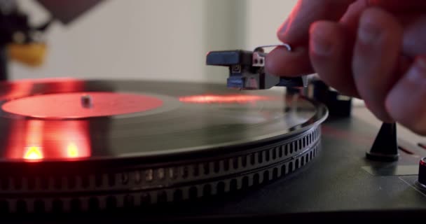 Hand turns on a vintage vinyl record and vinyl record is spinning. Slow motion — Stock Video