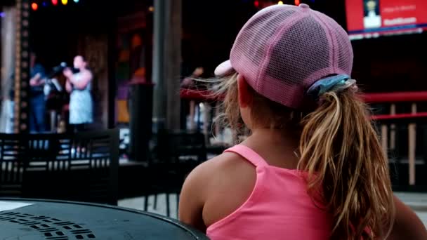 Niña mirando y animando en el público durante el concierto. — Vídeo de stock