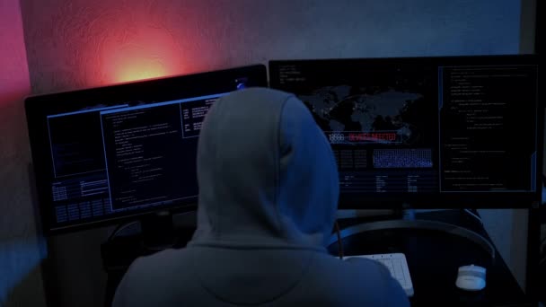 Unrecognizable hacker man typing on keyboard and engaging hacking into security systems. rear view — Vídeo de Stock