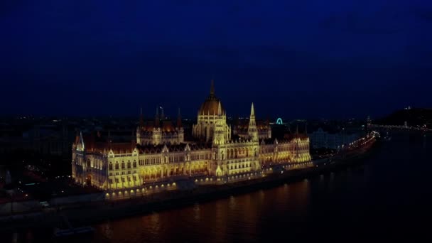 Drone wide footage of Danube river and Budapest city skyline at night time. — ストック動画