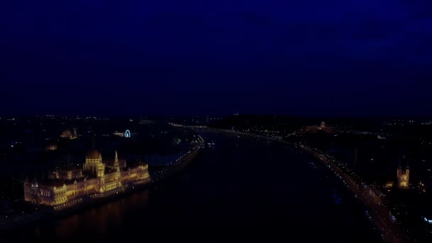 Aerial wide view of Danube river and Budapest city skyline at night time — стоковое видео