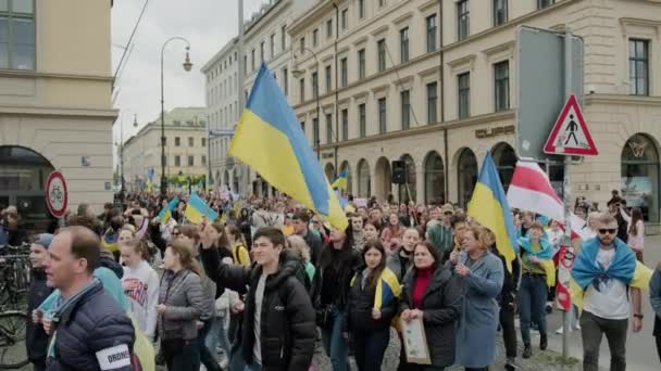 Le peuple ukrainien proteste dans les rues de Munchen contre la guerre et contre la Russie. personnes avec pancartes, drapeaux Europe, Deutschland Munchen, mai 2022 — Video