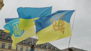 Ukraynalılar Münih sokaklarında savaşı protesto ediyorlar. Ukrayna bayrakları. Yüksek kalite 4k görüntü