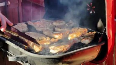 BBQ marinated and smoked chicken spareribs on the hot charcoal gril . High quality 4k footage