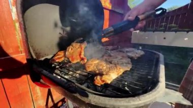 BBQ marinated and smoked chicken spareribs on the hot charcoal gril . High quality 4k footage