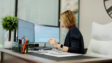 Woman sit at desk using computer, make data analysis, check statistics research, workday in office. . High quality 4k footage