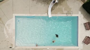 Group of children enjoying outdoor time in a beautiful pool. Top view. High quality 4k footage