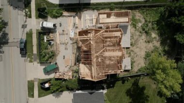 Aerial top view of workers building new residential home. High quality 4k footage