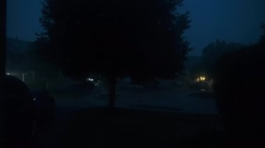 Şiddetli yağmur, gök gürültülü ve şimşekli, banliyö yerleşim yeri caddesi. Yüksek kalite 4k görüntü