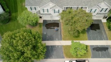 Aerial view of Driveway sealcoating pavement, Near private houses in the suburbs. High quality 4k footage