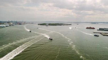 Aerial view of flying to the right behind Staten Island Ferry as it approaches downtown NYC. High quality 4k footage