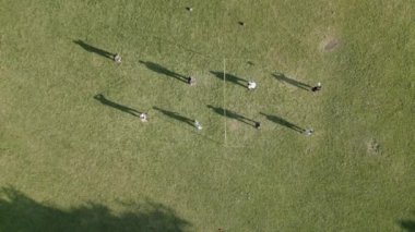 Aerial view of drone shot of people playing volleyball in park . High quality 4k footage
