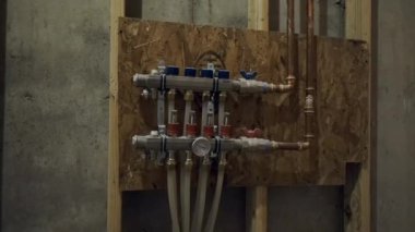 Installing basement heating pipes for water heating. High quality 4k footage