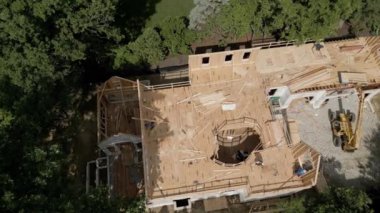 Aerial top view of workers building new residential home. High quality 4k footage
