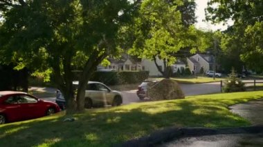 Rotating Sprinkler Watering a Fenced in Yard Passing Through the Sun Near Sunset in the suburbs. High quality 4k footage