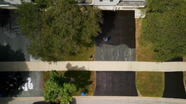 Aerial view of Driveway sealcoating pavement, Near private houses in the suburbs. High quality 4k footage
