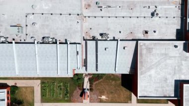 Drone view of an industrial roof, Roofers installing a new roof on an industrial building. High quality 4k footage