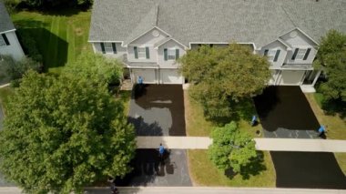 Aerial view of Driveway sealcoating pavement, Near private houses in the suburbs. High quality 4k footage