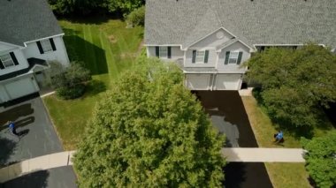 Aerial view of Driveway sealcoating pavement, Near private houses in the suburbs. High quality 4k footage