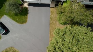Aerial view of Driveway sealcoating pavement, Near private houses in the suburbs. High quality 4k footage