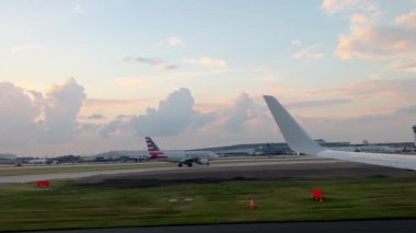 Air plane airlines approaches the runway and prepares for take off. Wide View of the wing from the porthole. High quality 4k footage