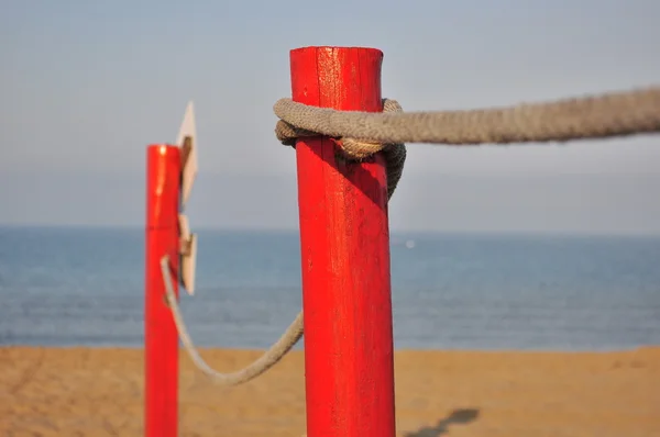 Red pole on the beach — Stock Photo, Image