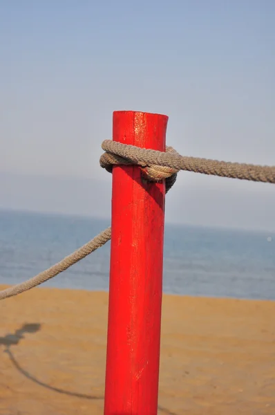 Красный столб на пляже — стоковое фото