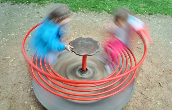 Red children carousel spinning round — Stock Photo, Image