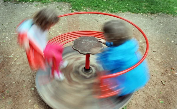 Red children carousel spinning round — Stock Photo, Image