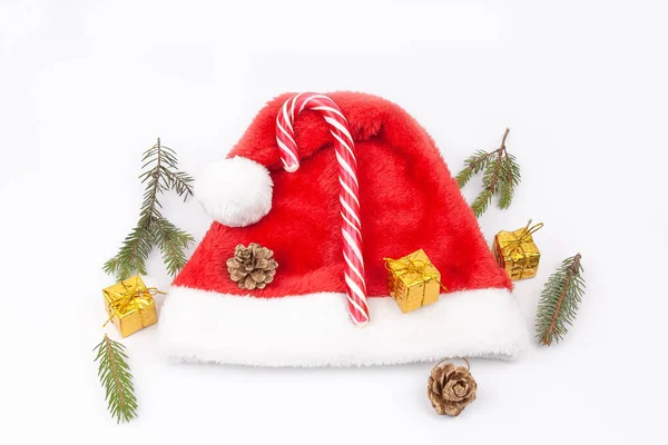 Пихта Ветви Шишки Карамельный Тростник Подарок Шляпе Санта Клауса Белом — стоковое фото