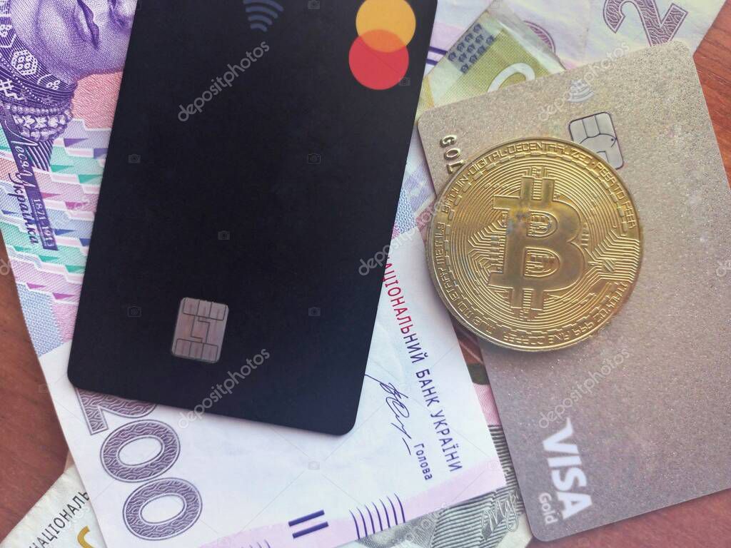 Kropyvnytskyy UKRAINE - March 19, 2022: Credit Card Master Card and new banknotes with a face value of 500, 200 and 100 hryvnia. Ukrainian money. Business concept.